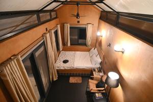 an overhead view of a small room with a bed at Tenpy Tiny Scenic Garfield @ T-Stop, Coorg in Virajpet