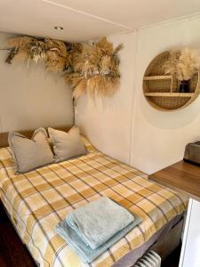 a bedroom with a bed with towels on it at Apple tree hut, in a private garden in Skipton