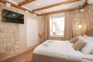 Ein Bett oder Betten in einem Zimmer der Unterkunft Mascheroni Luxury Rooms
