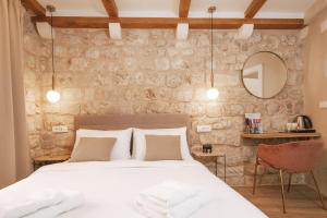 Ein Bett oder Betten in einem Zimmer der Unterkunft Mascheroni Luxury Rooms