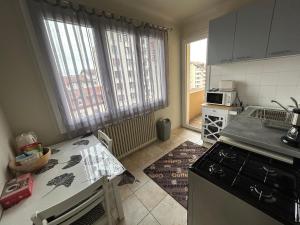 a kitchen with a sink and a stove top oven at Harmony Studio in Annecy