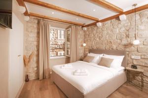Ein Bett oder Betten in einem Zimmer der Unterkunft Mascheroni Luxury Rooms