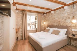 Ein Bett oder Betten in einem Zimmer der Unterkunft Mascheroni Luxury Rooms