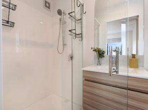 a bathroom with a glass shower and a sink at Entire Brand New Home in Christchurch +21 photos