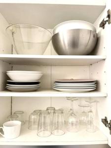 a kitchen shelf filled with dishes and bowls and plates at Bercy Arena 2 in Paris