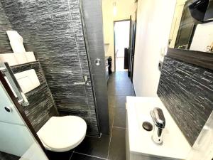 a bathroom with a toilet and a sink and a shower at Bercy Arena 2 in Paris