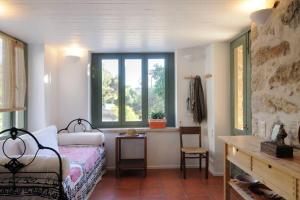 a bedroom with a bed and a window at Dolly's Dream House in Patmos