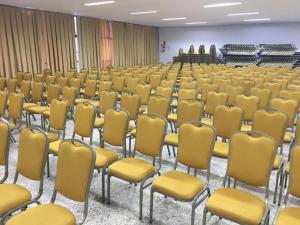 a room with rows of chairs and a podium at Hotel Crystal Place in Goiânia