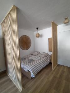 een kleine slaapkamer met een bed in een kamer bij STUDIO AVEC COIN NUIT in Roquebrune-Cap-Martin