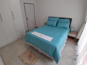 a bedroom with a blue bed with a box on it at Merensky house in Roodepoort