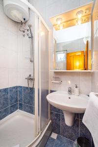 a bathroom with a sink and a shower at Apartments Prkačin 2 in Starigrad-Paklenica