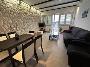 a living room with a couch and a table at Perina Apartment - free parking in Dubrovnik