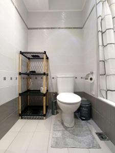 a bathroom with a white toilet in a room at Kallaris Deluxe House in Thessaloniki