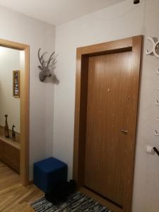 een kamer met een deur en een hertenkop aan de muur bij Apartamentai 78 in Mažeikiai