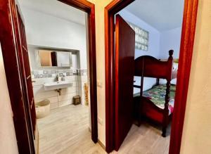 a bathroom with a mirror and a bed and a sink at CASTAGNA BIANCA - Tuscan ToBe srl in Santa Fiora