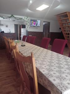 a dining room with a long table and chairs at CABANA NICU&DORi in Sibiu