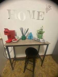 a table with a chair and a sign that reads home at Casa Elisa 8 in Bellaria-Igea Marina