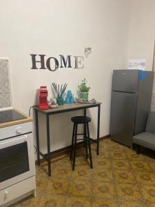 a kitchen with a table and a refrigerator at Casa Elisa 8 in Bellaria-Igea Marina +9 photos