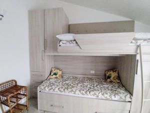 a small bedroom with a bunk bed in a loft bed at Mansarda di Masha in Villongo SantʼAlessandro