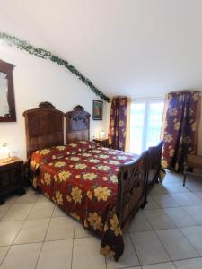 a bedroom with a bed with a red comforter at Mansarda di Masha in Villongo SantʼAlessandro