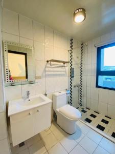 a bathroom with a white toilet and a sink at Pengjia Villa in Hengchun South Gate