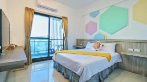 a bedroom with a bed and a large window at Pengjia Villa in Hengchun South Gate