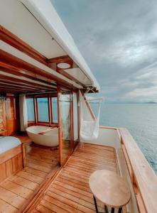 a boat with a bed and a tub on the deck at Dav-Venture in Labuan Bajo