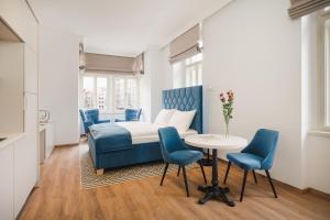 um quarto com uma cama, uma mesa e cadeiras em NOBILIS RESIDENCE em Praga