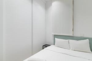 - une chambre avec un lit doté de draps et d'oreillers blancs dans l'établissement Modern and cozy-1Bedroom 1Bathroom-Azca, à Madrid