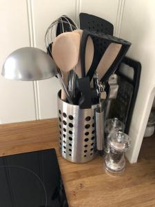 a container filled with utensils on a table at Green Valley, Cotswold stay with hamper in Cheltenham