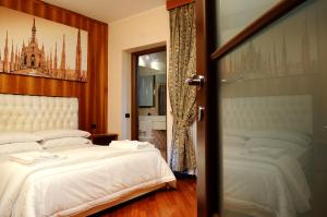 Postel nebo postele na pokoji v ubytování Hotel Malpensafiera