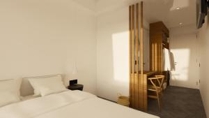 a bedroom with a white bed and a wooden closet at Pontikonisi Hotel & Suites in Perama