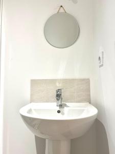 a bathroom with a white sink and a mirror at M024 Studio avec balcon gare in Annemasse