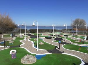 a park with a playground with rocks and water at 21 Riverview, Allhallows in Rochester