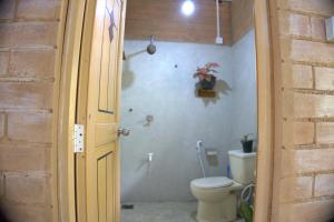 a bathroom with a toilet in a room at PASSIONFRUIT HOMESTAY in Matara