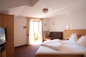 Postel nebo postele na pokoji v ubytování Hotel & Residence Rebhof