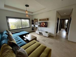a living room with a blue couch and a fireplace at BEST unit NEAR Casablanca AIRPORT in Casablanca