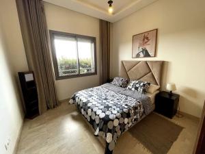 a bedroom with a bed and a window at BEST unit NEAR Casablanca AIRPORT in Casablanca