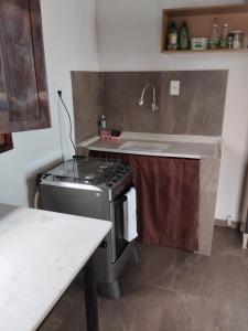a kitchen with a sink and a stove at Xareu-Balanço das Ondas! in Cabo de Santo Agostinho +46 photos