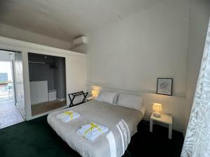 a bedroom with a bed and a large window at Maison Leone Apartment in Ravenna