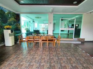 a dining room with a table and chairs at Sweet Cenang Memories Inn in Pantai Cenang