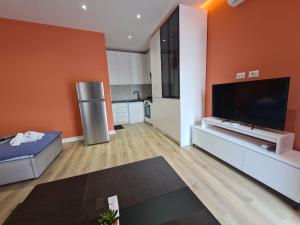 a large living room with an orange wall at Tirana Center Apartaments in Tirana