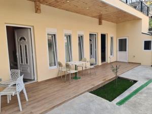 a patio with chairs and a table on a wooden deck at Tirana Center Apartaments in Tirana