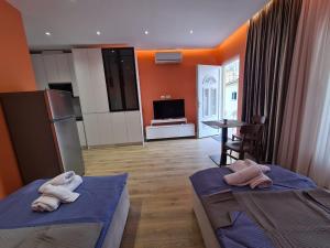two beds in a room with two towels on them at Tirana Center Apartaments in Tirana