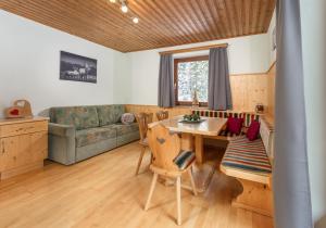 a living room with a table and a couch at Winklhütte in Forstau