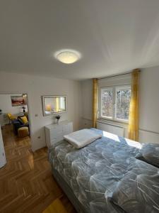 a bedroom with a large bed and a window at Sweet yellow in Zagreb