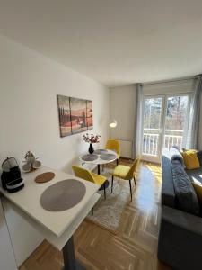 a living room with a couch and a table at Sweet yellow in Zagreb +10 photos