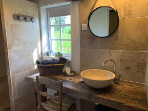 a bathroom with a sink and a mirror on a counter at Gite le Normand in Vimoutiers