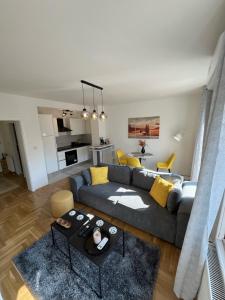 a living room with a couch and a table at Sweet yellow in Zagreb