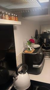 a kitchen with a tea kettle on a stove at Dar Kareem in Villeparisis